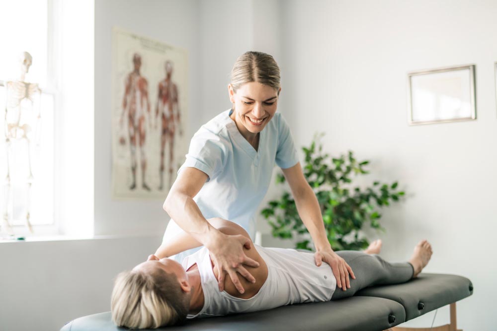 Patient getting arms and hips chiropractic treatment
