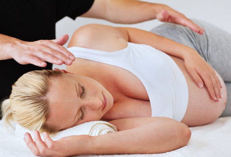 Pregnant woman getting chiropractic treatment